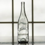 750 ml clear wine bottle with sloped shoulder.